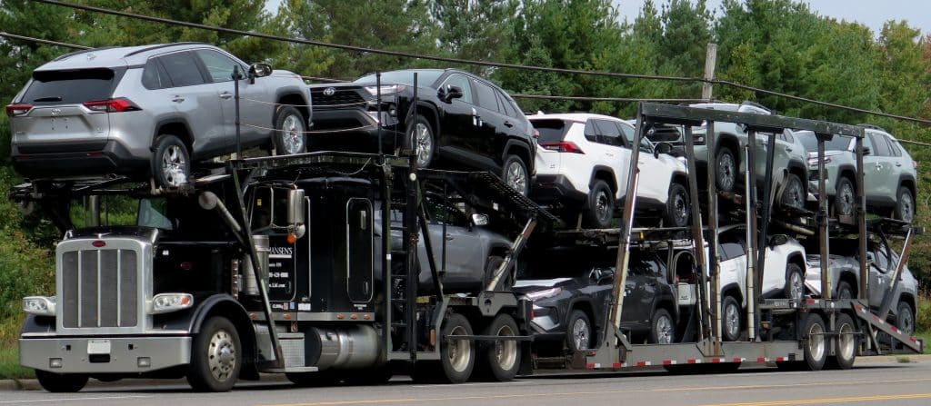 vehicle transportation across states using an open carrier truck